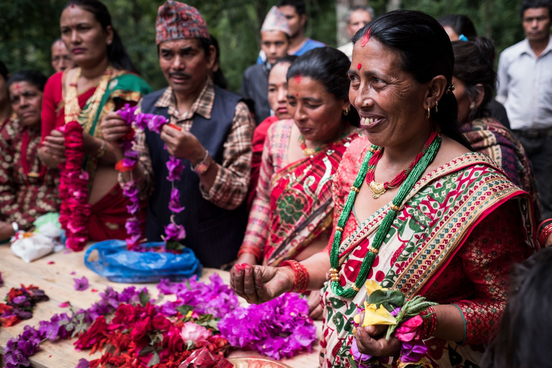 Members of the Chaubas Community Forest Users Group wait with garlands to greet members visiting with the Crawford Fund and Landline group. The group is predominantly made up of women and they are highly engaged in the silvicultural management of community forests and have been farming cardamom in Fagar Khola community forest for the past two years. Cardamom is a high value crop that requires little maintenance once it's been planted and leads to additional income for the female farmers.