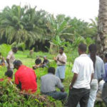Dr Banabas talking to farmers in an oil palm food crop intercropping demonstration block (Photo 2011)