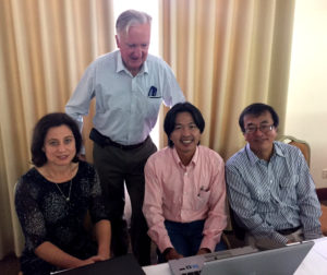 At the workshop with Dr Jayne Curnow, social scientist at IWMI, Dr Chea Sareth, Head Socio Economics at CARDI, Cambodia and Professor Shu Fukai University of Queensland. Studying a presentation on intensification of rice production on day two of the workshop. Chea is a PhD graduate from UQ