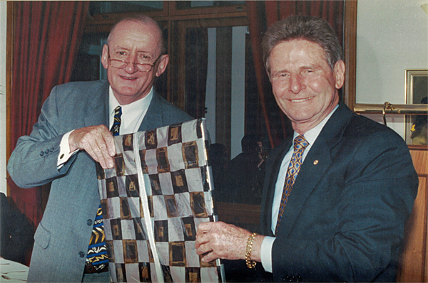 The Hon Tim Fischer (L), then Chair of the Crawford Fund, presents a retirement gift to Don Mentz in 2002
