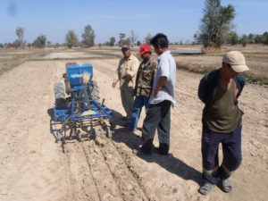Alan Wattana farmers seeding the first drill-seeding trials with a prototype seeder, December 2013
